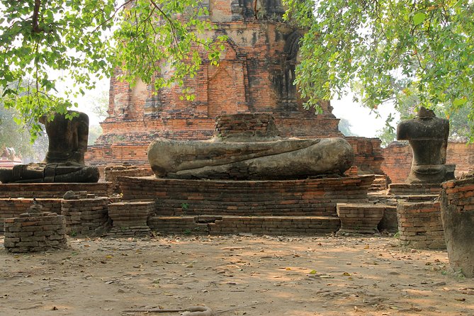 Ayutthaya Day Tour By Coach and Cruise - Wat Mahathat: the famous Buddha head in tree roots