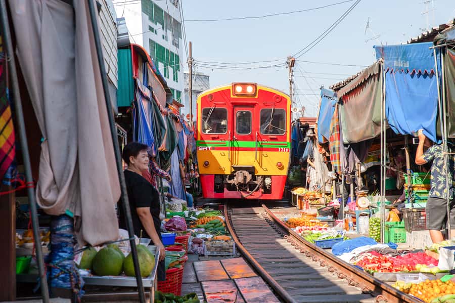 From Bangkok: Maeklong Railway and Floating Market Food Tour - Mae Klong Railway Market: where the train passes inches from vendors