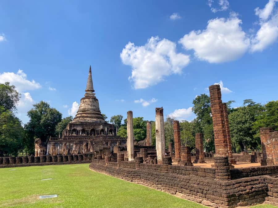 From Chiang Mai: Customize Your Own Sukhothai Heritage Tour - Wat Traphang Ngoen: pond reflections and a Buddha on a pedestal