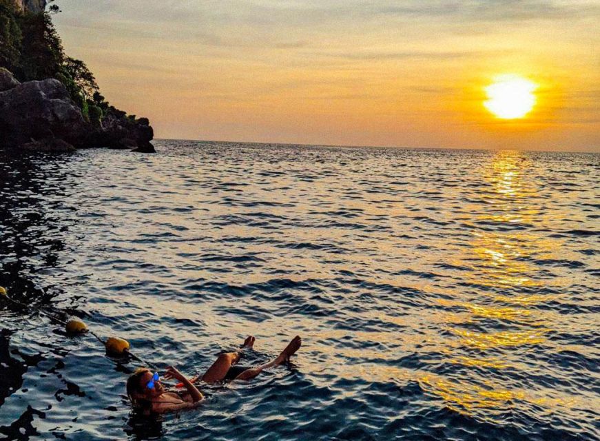 From Phi Phi: Sunset & Bioluminescent Plankton Snorkel Tour - The sunset on board: fruit, sea breeze, and a changing sky