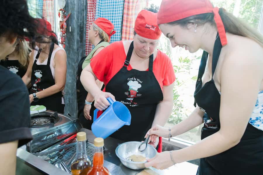 Phuket: Authentic Thai Cooking Class - Inside the Cooking School: Welcome Drink, Clean Stations, Real Instruction