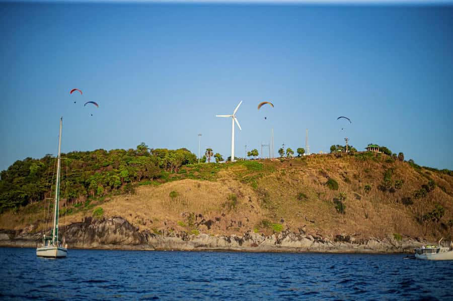 Phuket: Coral Island Day Trip and Sunset Dinner by Catamaran - The catamaran cruise: from Kahung Island stretches to Promthep Cape views