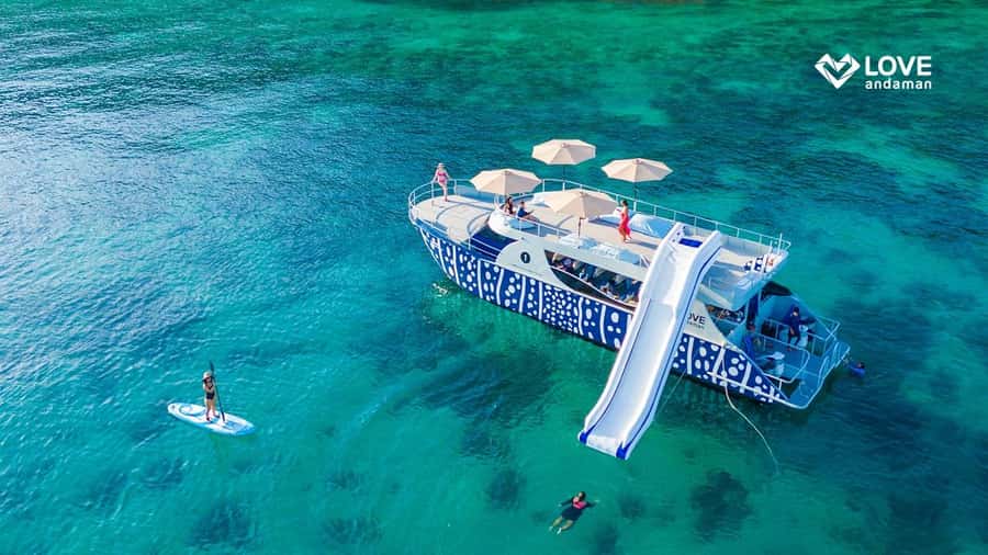 Phuket: Phi Phi Maiton Island Sunset Premium Catamaran Tour - Maiton Private Island: Paddleboarding, Bean Bags, and Slide Time