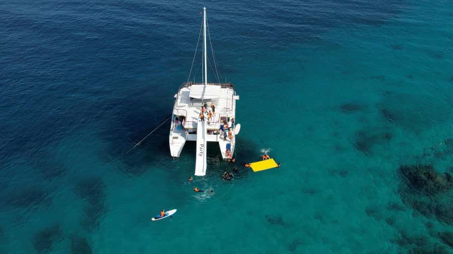 Phuket: Racha & Coral Island Catamaran Tour With Foam Party - Racha Island and the included water toys: slide, paddle board, and hand-line fishing