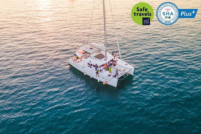 Sunset Cruise to Koh Hey in Phuket by Sailing Catamaran - Beach block on Koh Hey: shade, sea sports, and the small frictions