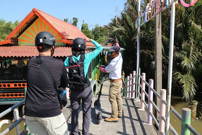 Take a E-Scooter Ride in Bangkok's Jungle - Sri Nakhon Khuean Khan Park: shade, a lake, and fish-feeding time